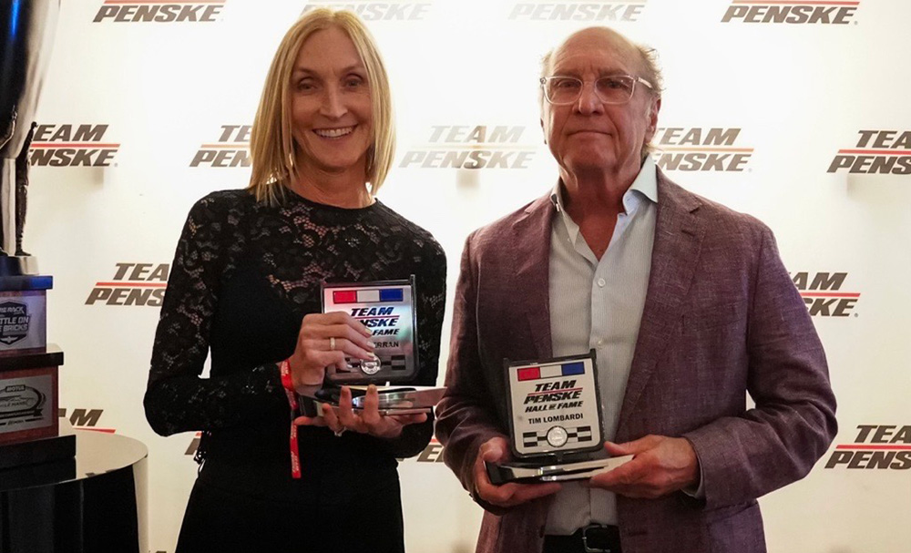 Gil de Ferran's wife Angela and Tim Lombardi receive the Team Penske Hall of Fame awards in 2024.